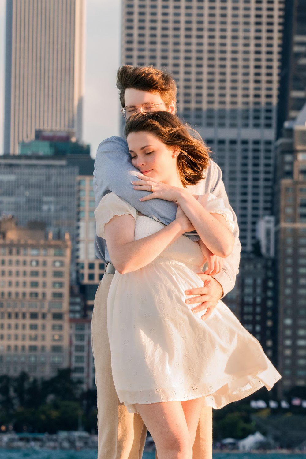 Tess folded into Hank’s arms at the lakefront, the skyline behind